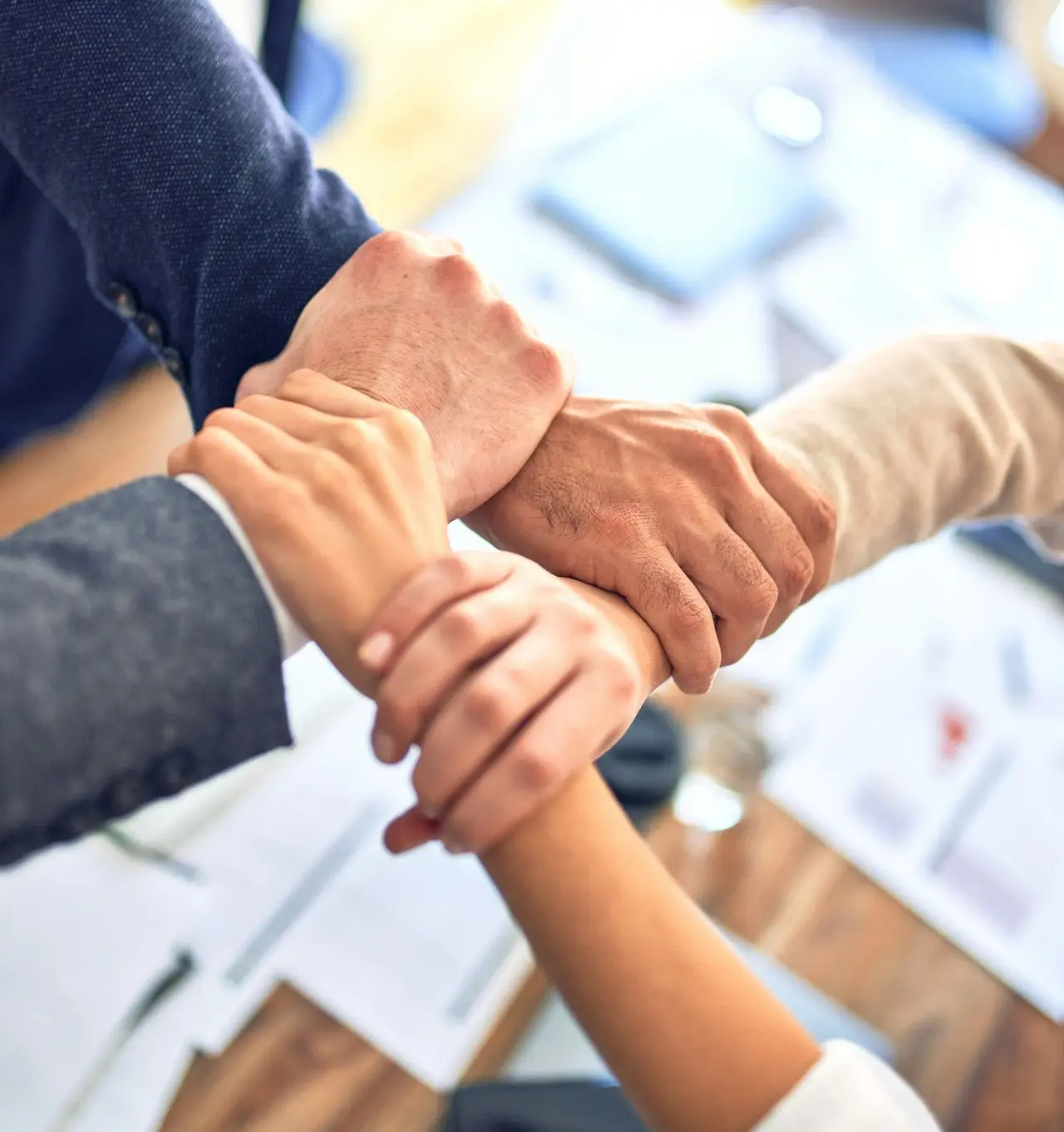 person in black long sleeve shirt holding persons hand